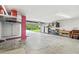 Spacious garage area with ample storage racks and bright lighting at 3227 Rose Arbor Dr, Hernando Beach, FL 34607