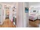 Hallway view showcasing a laundry area, bathroom and a bedroom with hardwood flooring and neutral paint scheme at 3227 Rose Arbor Dr, Hernando Beach, FL 34607