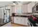 Kitchen featuring stainless steel appliances, black countertops, and pink walls at 3227 Rose Arbor Dr, Hernando Beach, FL 34607