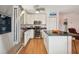 Kitchen with stainless steel appliances, white cabinetry, and kitchen island at 3227 Rose Arbor Dr, Hernando Beach, FL 34607
