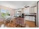 Eat-in kitchen with center island, white cabinets, and stainless steel appliances at 3227 Rose Arbor Dr, Hernando Beach, FL 34607