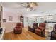 Spacious living room featuring wood floors, comfortable seating, and natural light at 3227 Rose Arbor Dr, Hernando Beach, FL 34607