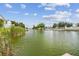 Beautiful waterfront view featuring a canal, lush vegetation, and serene residential surroundings on a sunny day at 3227 Rose Arbor Dr, Hernando Beach, FL 34607