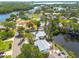 Waterfront home with dock, screened in area, and lush tropical landscaping at 328 Tallahassee Ne Dr, St Petersburg, FL 33702