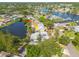 Waterfront home with lush tropical landscaping and mature trees on a sunny day at 328 Tallahassee Ne Dr, St Petersburg, FL 33702