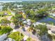 Waterfront home with lush tropical landscaping and mature trees on a sunny day at 328 Tallahassee Ne Dr, St Petersburg, FL 33702