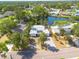 Waterfront home with lush tropical landscaping and mature trees on a sunny day at 328 Tallahassee Ne Dr, St Petersburg, FL 33702