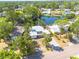 Waterfront home with lush tropical landscaping and mature trees on a sunny day at 328 Tallahassee Ne Dr, St Petersburg, FL 33702