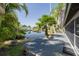 Backyard deck overlooking a serene pond with lush tropical landscaping at 328 Tallahassee Ne Dr, St Petersburg, FL 33702