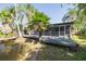 Backyard deck with a pond and tropical landscaping surrounding the home at 328 Tallahassee Ne Dr, St Petersburg, FL 33702