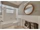 Bathroom in need of repair featuring a tub, toilet, window and damage behind the toilet at 328 Tallahassee Ne Dr, St Petersburg, FL 33702