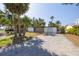 Inviting home exterior showcasing paver driveway, garage, and decorative privacy screen, all surrounded by lush palm trees at 328 Tallahassee Ne Dr, St Petersburg, FL 33702