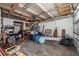 Cluttered garage with storage shelves, tools, and an overhead door at 328 Tallahassee Ne Dr, St Petersburg, FL 33702