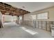 Bright, partially renovated living room with large windows, and exposed ceiling beams, ready for new finishes at 328 Tallahassee Ne Dr, St Petersburg, FL 33702