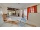 Spacious living room undergoing renovation with open ceiling, large sliding door, and exposed framework at 328 Tallahassee Ne Dr, St Petersburg, FL 33702