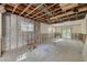 Partially renovated living room featuring exposed ceiling beams, large windows, and open floor plan at 328 Tallahassee Ne Dr, St Petersburg, FL 33702