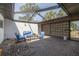 Covered brick patio with comfortable seating and a decorative screen, perfect for relaxing and entertaining outdoors at 328 Tallahassee Ne Dr, St Petersburg, FL 33702