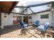 Covered brick patio featuring stylish outdoor furniture, creating a cozy and inviting outdoor living space at 328 Tallahassee Ne Dr, St Petersburg, FL 33702