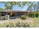 Backyard featuring a screened patio, lush landscaping, and mature trees at 35145 Whispering Oaks Blvd, Dade City, FL 33523