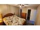 Cozy bedroom featuring a ceiling fan, wood floors, and a closet for ample storage space at 35145 Whispering Oaks Blvd, Dade City, FL 33523