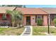 Charming single-story home featuring a pathway and a well-maintained front lawn with a palm tree at 35145 Whispering Oaks Blvd, Dade City, FL 33523