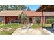 Well-maintained single-story home with covered parking, stepping stone walkway, and manicured lawn at 35145 Whispering Oaks Blvd, Dade City, FL 33523