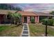 Charming single-story home with a manicured lawn, stepping stone walkway, and beautiful landscaping at 35145 Whispering Oaks Blvd, Dade City, FL 33523