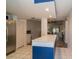 Open kitchen with a large quartz countertop and stainless steel refrigerator leading to the living area at 35145 Whispering Oaks Blvd, Dade City, FL 33523