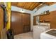 Utility room featuring a washer, dryer, and utility shelving with tile flooring at 35145 Whispering Oaks Blvd, Dade City, FL 33523