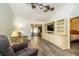 Bright and airy living room featuring a vaulted ceiling, built-in shelving, and sliding glass doors at 35145 Whispering Oaks Blvd, Dade City, FL 33523
