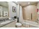 Well-lit bathroom features a granite countertop, framed mirror, and tiled shower with safety bar at 36750 Us 19 N # 07208, Palm Harbor, FL 34684