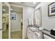 Bright bathroom featuring granite countertop, framed mirror, and access to other rooms at 36750 Us 19 N # 07208, Palm Harbor, FL 34684