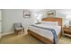 Bedroom with king bed, stylish chair, end tables, and tasteful artwork at 36750 Us 19 N # 07208, Palm Harbor, FL 34684