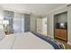 Bedroom with king bed, balcony access, TV, and dresser for storage at 36750 Us 19 N # 07208, Palm Harbor, FL 34684