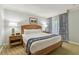 Bright bedroom with king bed, matching lamps, and blue patterned curtains at 36750 Us 19 N # 07208, Palm Harbor, FL 34684