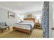 Bedroom with king bed features lamps, end tables, and tasteful artwork at 36750 Us 19 N # 07208, Palm Harbor, FL 34684