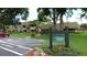 Well-maintained condo building with lush landscaping and a clearly marked sign at 36750 Us 19 N # 07208, Palm Harbor, FL 34684
