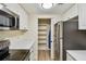 Contemporary kitchen with stainless steel appliances, white counters, and open pantry at 36750 Us 19 N # 07208, Palm Harbor, FL 34684