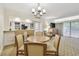 Inviting living area with a dining table, bar seating, and modern lighting fixtures at 36750 Us 19 N # 07208, Palm Harbor, FL 34684