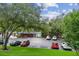 Expansive parking lot view with mature trees and building in background at 36750 Us 19 N # 07208, Palm Harbor, FL 34684
