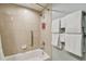 Shower and bath feature a grab bar, shower head and tiled walls at 36750 Us 19 N # 07208, Palm Harbor, FL 34684