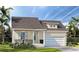 Charming single-Gathering home with a welcoming porch, light blue accents, and a well-manicured lawn at 3700 Rocky Island Rd, New Port Richey, FL 34655
