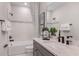 Well-lit bathroom with a tub-shower combo, stylish tile work, and modern fixtures at 37224 Clinch Cir, Zephyrhills, FL 33540