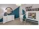 Playful bedroom with a house frame bed, a blue accent wall, and stylish decor at 37224 Clinch Cir, Zephyrhills, FL 33540
