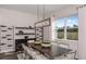 Elegant dining room with a large table, stylish chairs, and contemporary lighting, perfect for entertaining guests at 37224 Clinch Cir, Zephyrhills, FL 33540