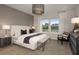 Serene main bedroom featuring a king-size bed, a chevron accent wall, and ample natural light at 37224 Clinch Cir, Zephyrhills, FL 33540