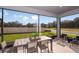 Spacious screened patio with a dining table and comfortable seating, perfect for outdoor entertaining at 37224 Clinch Cir, Zephyrhills, FL 33540