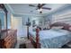 Cozy bedroom with paneled walls, a ceiling fan and a closet with mirrored doors at 402 12Th Sw St, Ruskin, FL 33570