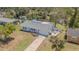 Single-story home with a well-maintained yard, a driveway, and an outdoor area for seating and recreation at 402 12Th Sw St, Ruskin, FL 33570