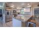 Modern kitchen with stainless steel appliances and a granite countertop island at 402 12Th Sw St, Ruskin, FL 33570